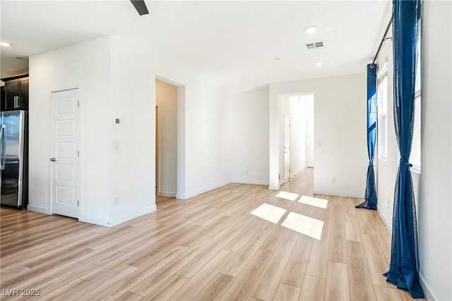 empty room with recessed lighting, visible vents, light wood-style flooring, and baseboards