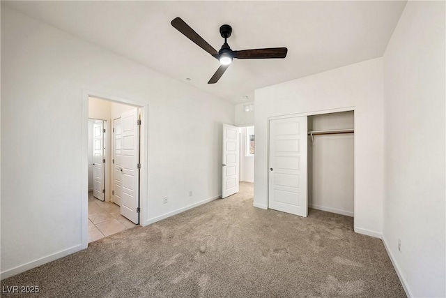 unfurnished bedroom with a closet, carpet flooring, a ceiling fan, and baseboards