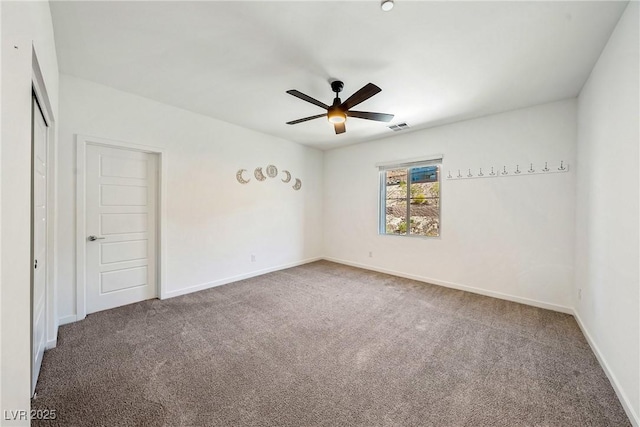 unfurnished room with a ceiling fan, baseboards, visible vents, and carpet flooring