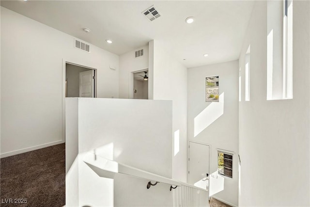 interior space featuring carpet, visible vents, baseboards, and recessed lighting