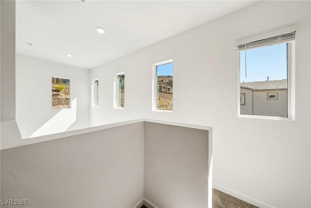 interior space with baseboards and recessed lighting