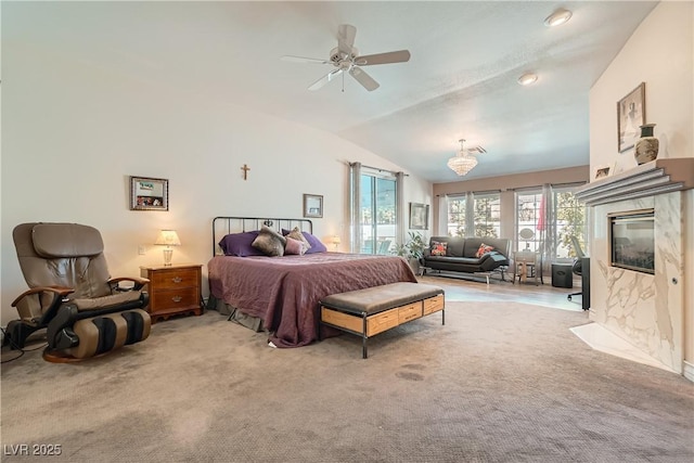 carpeted bedroom with a premium fireplace and vaulted ceiling