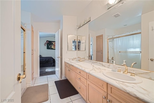 bathroom featuring double vanity, a sink, visible vents, and tile patterned floors