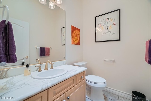 bathroom featuring toilet, vanity, and tile patterned floors