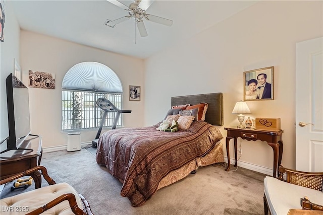 carpeted bedroom with ceiling fan and baseboards