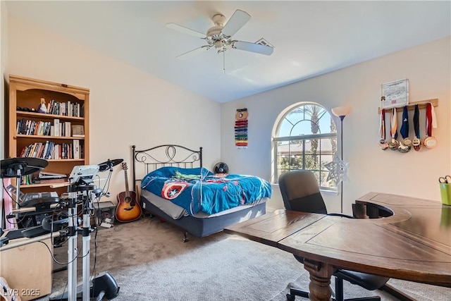 carpeted bedroom featuring ceiling fan and vaulted ceiling