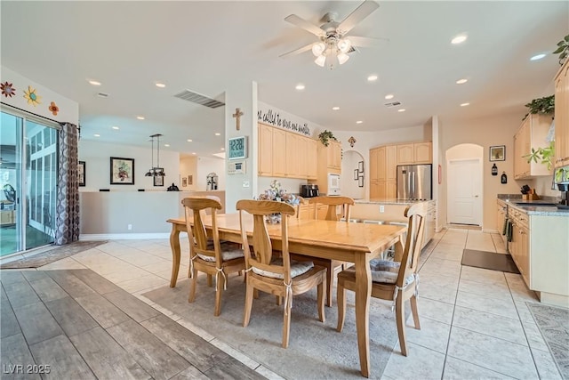 dining space featuring light tile patterned floors, arched walkways, visible vents, and recessed lighting