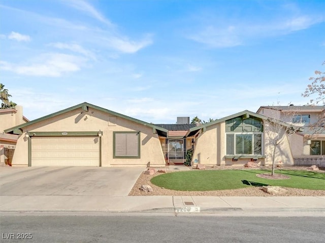 view of front of home with metal roof, a garage, driveway, stucco siding, and a front lawn