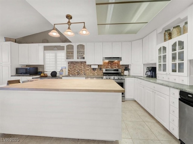 kitchen with tasteful backsplash, stainless steel appliances, under cabinet range hood, white cabinetry, and light tile patterned flooring