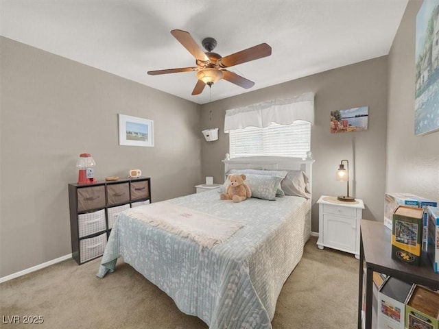 carpeted bedroom with baseboards and a ceiling fan