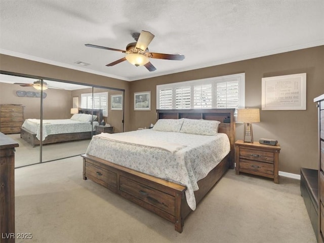 bedroom with light carpet, crown molding, a textured ceiling, and baseboards