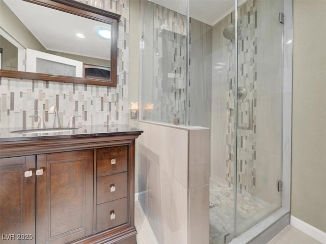 full bath featuring a shower stall, baseboards, and vanity