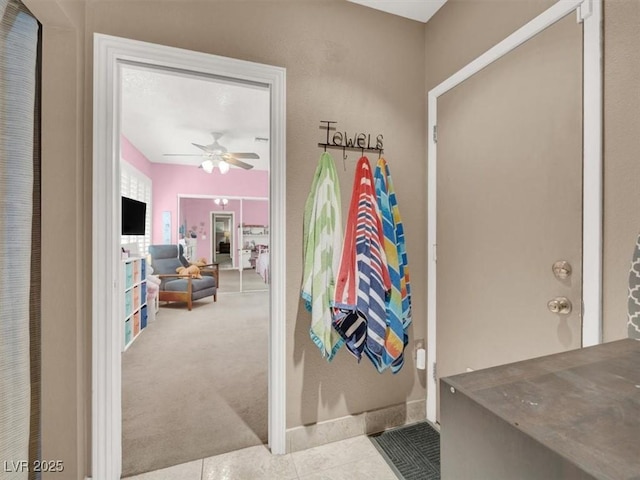 bathroom featuring a ceiling fan and tile patterned flooring