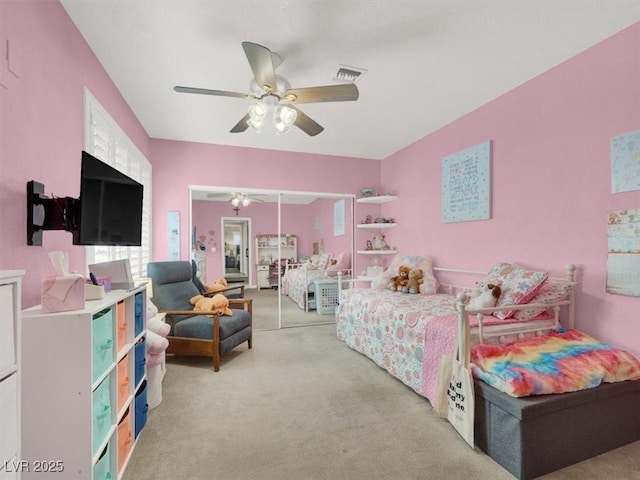 bedroom with light carpet, visible vents, and a ceiling fan