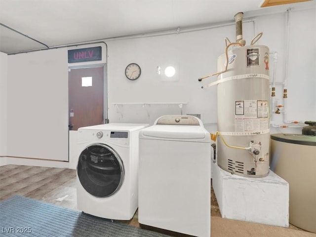 clothes washing area with water heater, laundry area, and washing machine and dryer