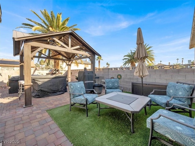 view of patio featuring a gazebo and a fenced backyard