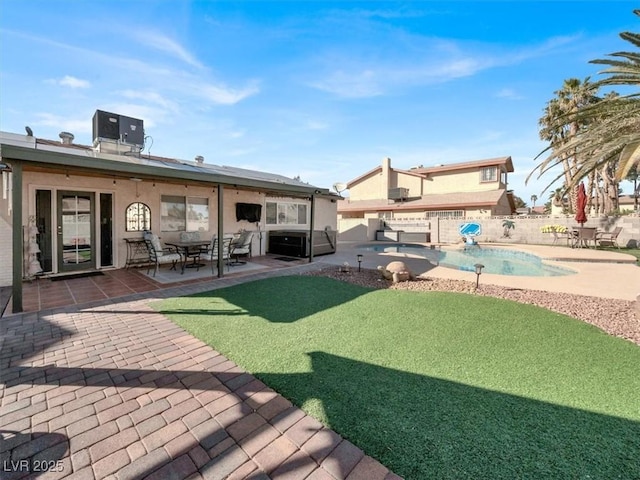 exterior space with a fenced in pool, cooling unit, a fenced backyard, and a patio