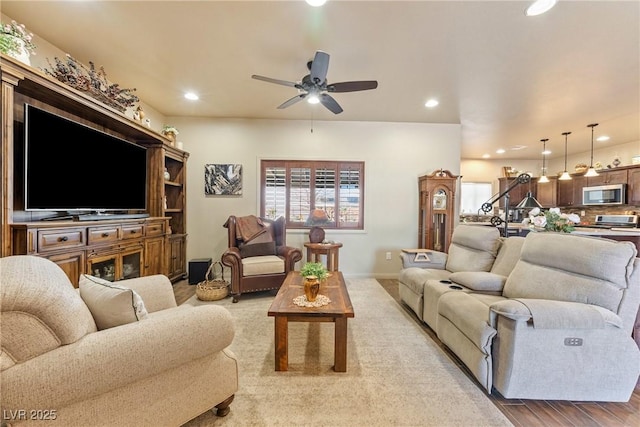 living room featuring ceiling fan, baseboards, wood finished floors, and recessed lighting