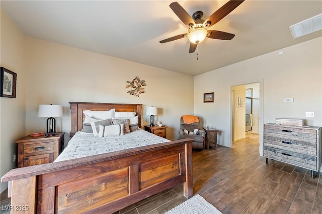 bedroom with ceiling fan, visible vents, and dark wood finished floors