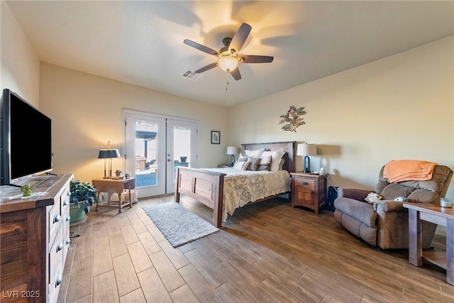 bedroom with french doors, visible vents, a ceiling fan, wood finished floors, and access to outside