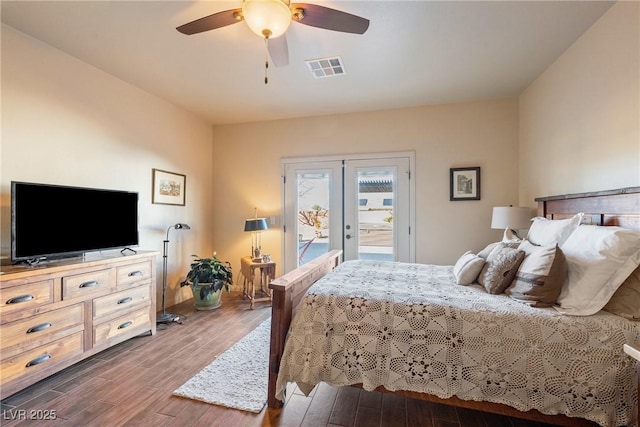 bedroom featuring visible vents, ceiling fan, wood finished floors, access to outside, and french doors