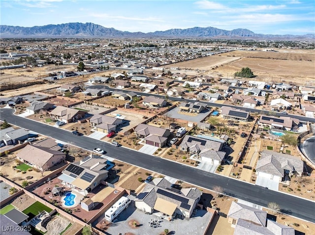 drone / aerial view featuring a residential view and a mountain view