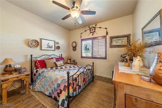 bedroom with wood finished floors, a ceiling fan, and baseboards