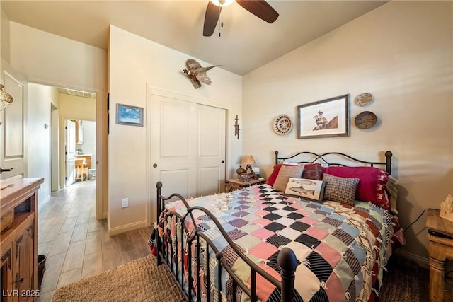 bedroom with light wood finished floors, visible vents, ceiling fan, vaulted ceiling, and a closet