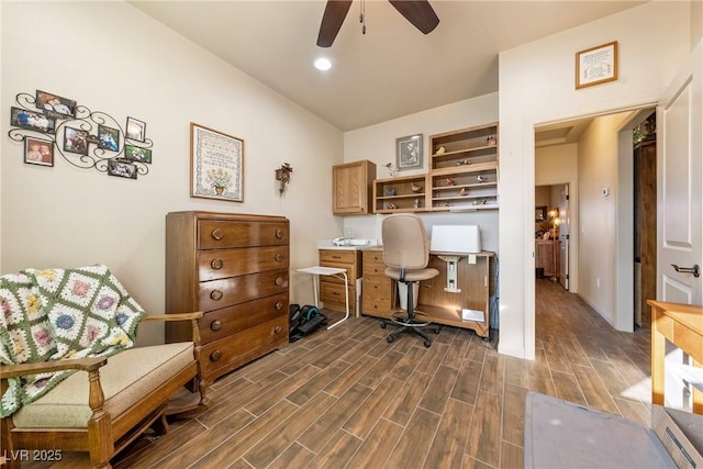 office featuring vaulted ceiling, a ceiling fan, and wood finish floors