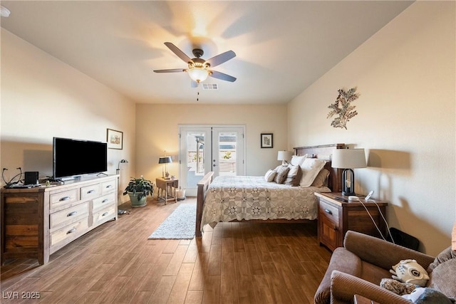 bedroom with ceiling fan, dark wood-type flooring, visible vents, access to exterior, and french doors