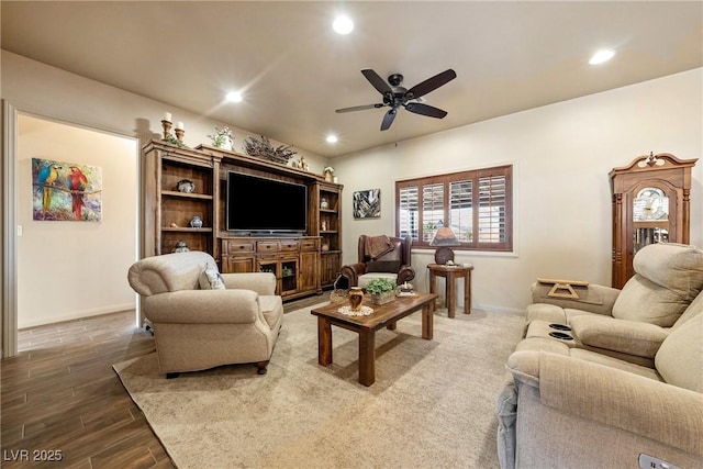 living area featuring baseboards, wood finished floors, a ceiling fan, and recessed lighting