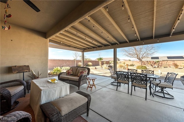 view of patio featuring outdoor dining area, a fenced backyard, and an outdoor living space