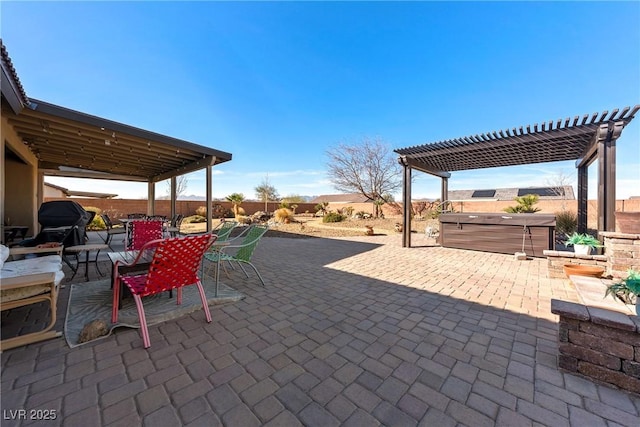 view of patio / terrace with a hot tub, a pergola, and outdoor dining space