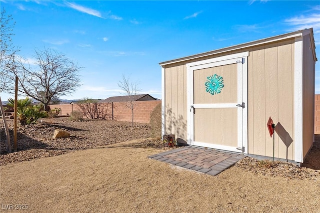 view of shed with fence