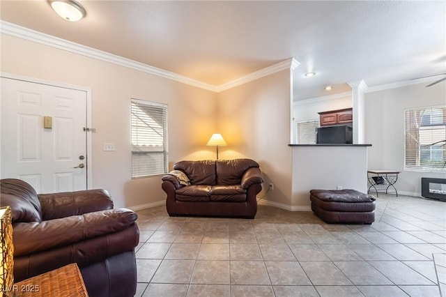 living room with light tile patterned floors, a wealth of natural light, and crown molding