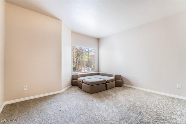 sitting room featuring carpet floors and baseboards