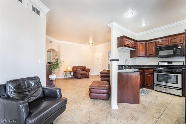 kitchen featuring black microwave, light tile patterned floors, stainless steel gas range oven, open floor plan, and dark countertops