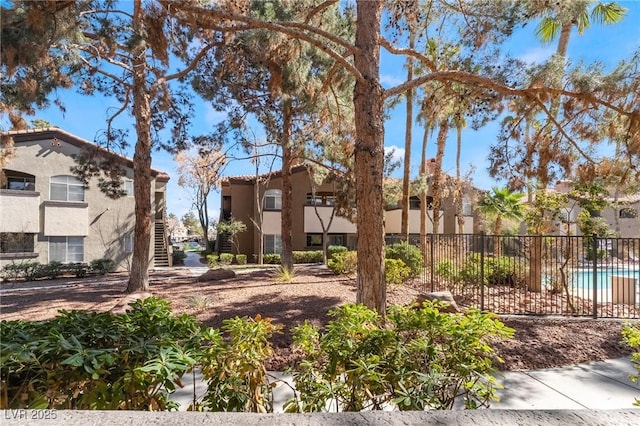 view of home's community with stairway, a residential view, and fence