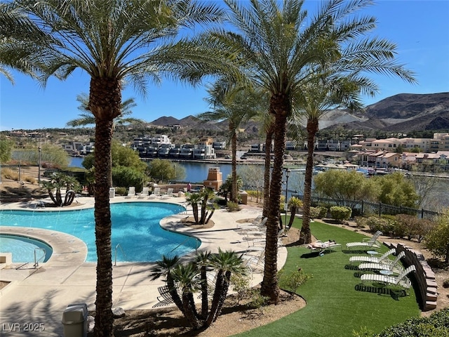 community pool with fence and a mountain view