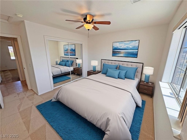 bedroom with ceiling fan, a closet, and carpet flooring