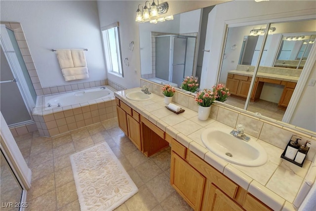 bathroom with double vanity, a stall shower, a sink, and a bath