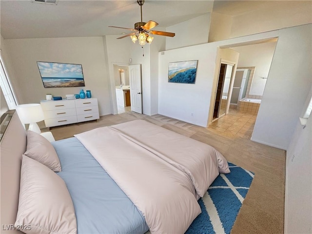 bedroom featuring visible vents, ensuite bathroom, a ceiling fan, carpet flooring, and vaulted ceiling
