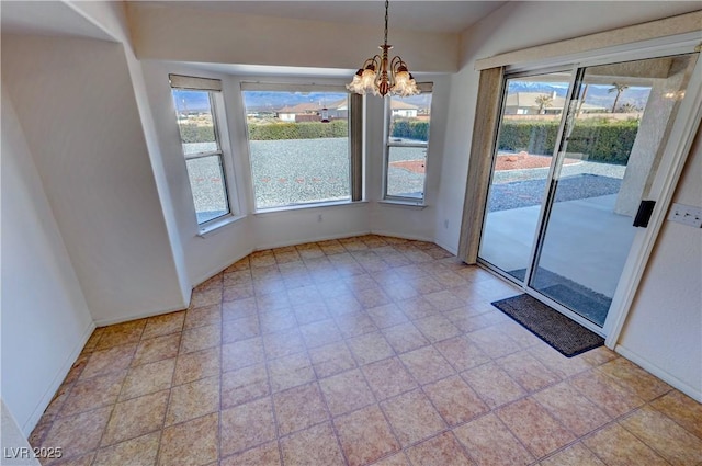 interior space with a chandelier and baseboards