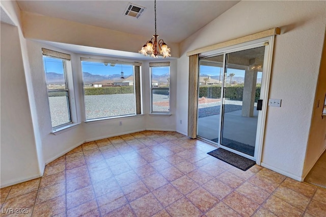 spare room featuring lofted ceiling, baseboards, visible vents, and a chandelier