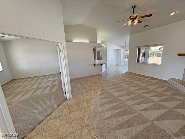 unfurnished room featuring light carpet, ceiling fan, visible vents, and high vaulted ceiling