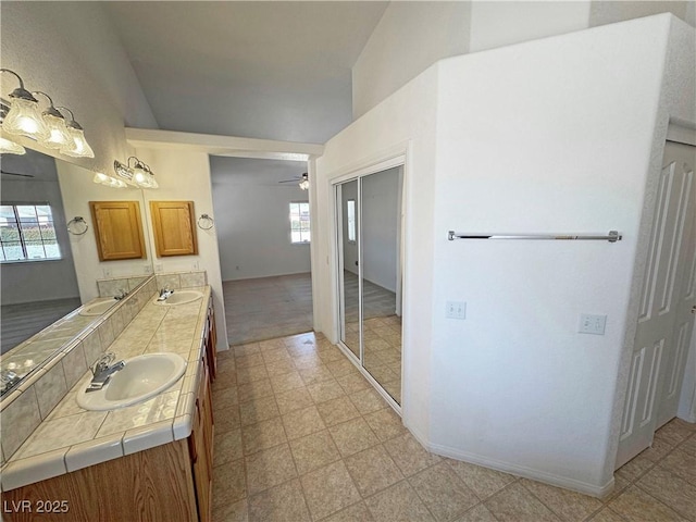 full bath featuring a healthy amount of sunlight, double vanity, and a sink