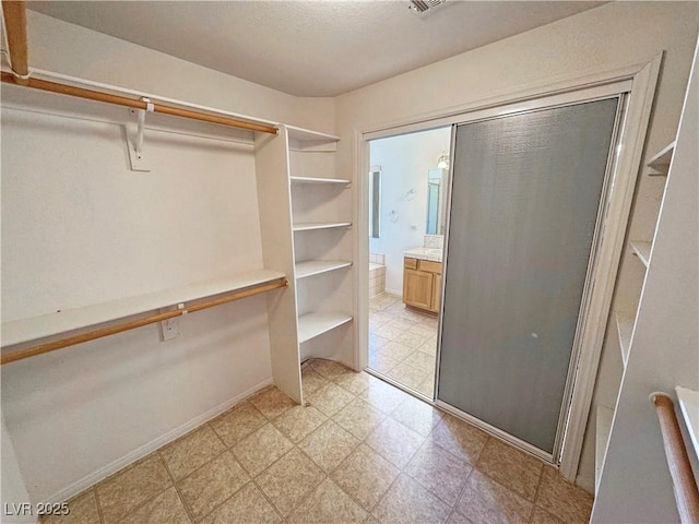 spacious closet featuring light floors