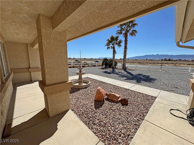view of patio / terrace with a mountain view