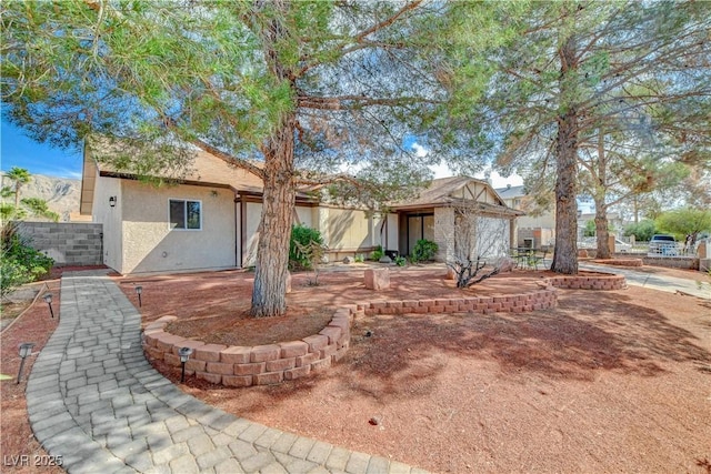 view of front of property with fence and stucco siding