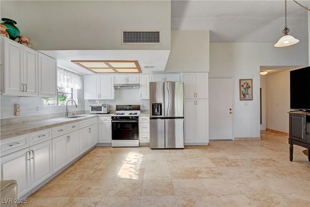 kitchen with visible vents, white cabinets, white gas stove, under cabinet range hood, and stainless steel refrigerator with ice dispenser